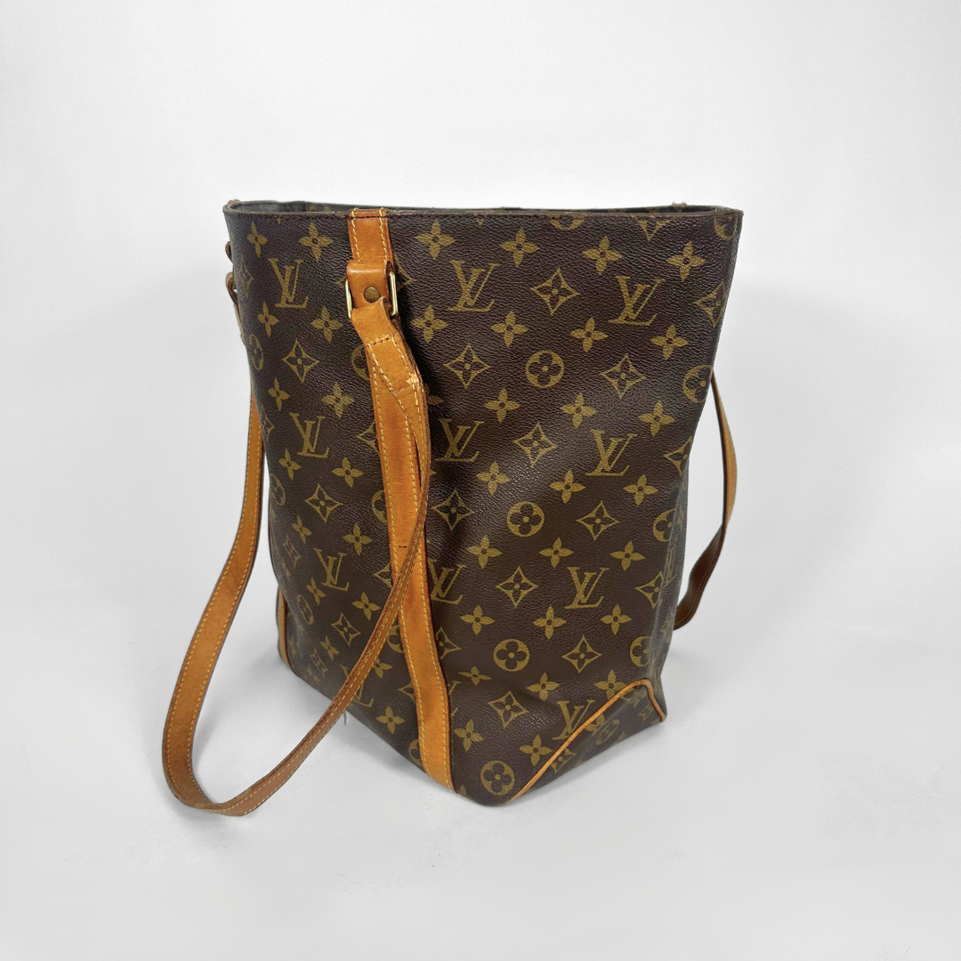 Designer handbag with monogram pattern on a white background