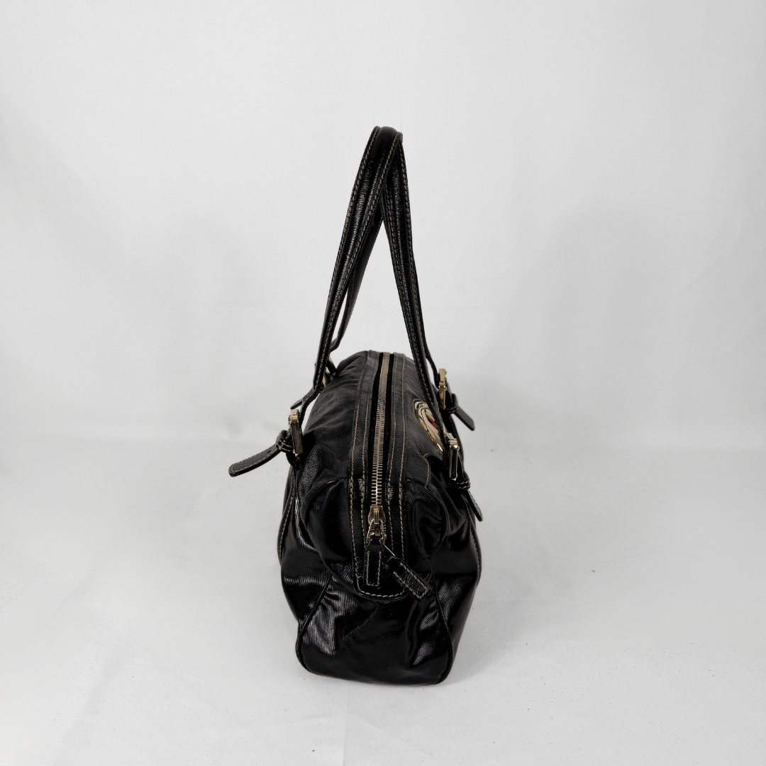 Gucci Dialux Britt Boston bag in signature Dialux canvas displayed on a light grey background.