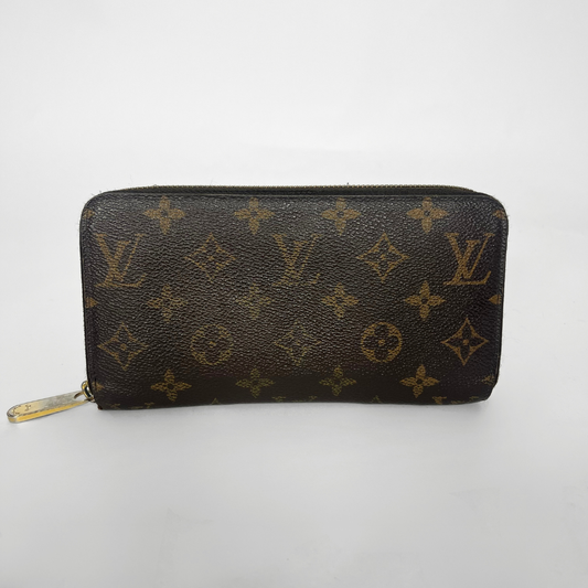 Louis Vuitton wallet with monogram pattern on a white background