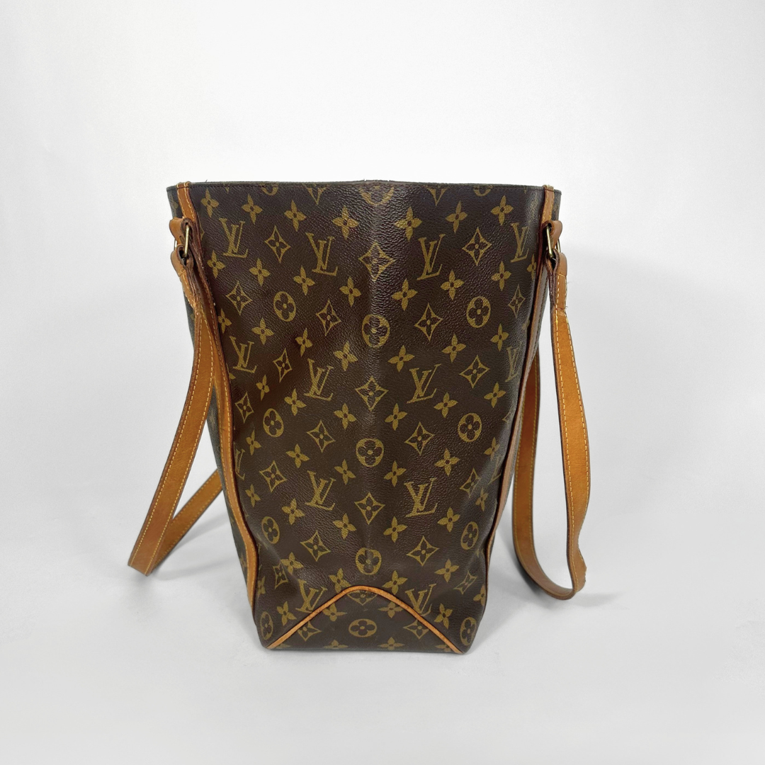 Designer handbag with monogram pattern on a white background