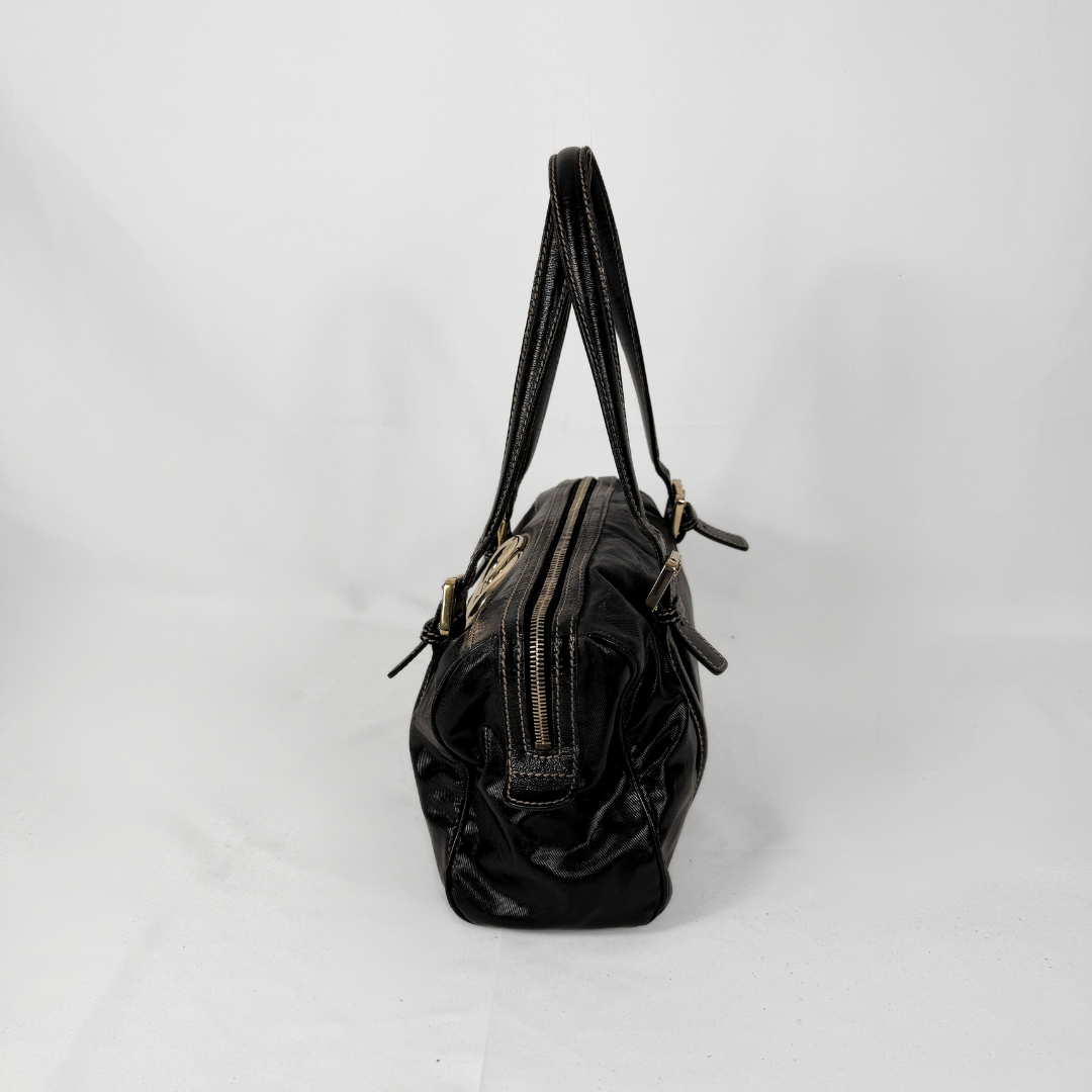 Gucci Dialux Britt Boston bag in signature Dialux canvas displayed on a light grey background.