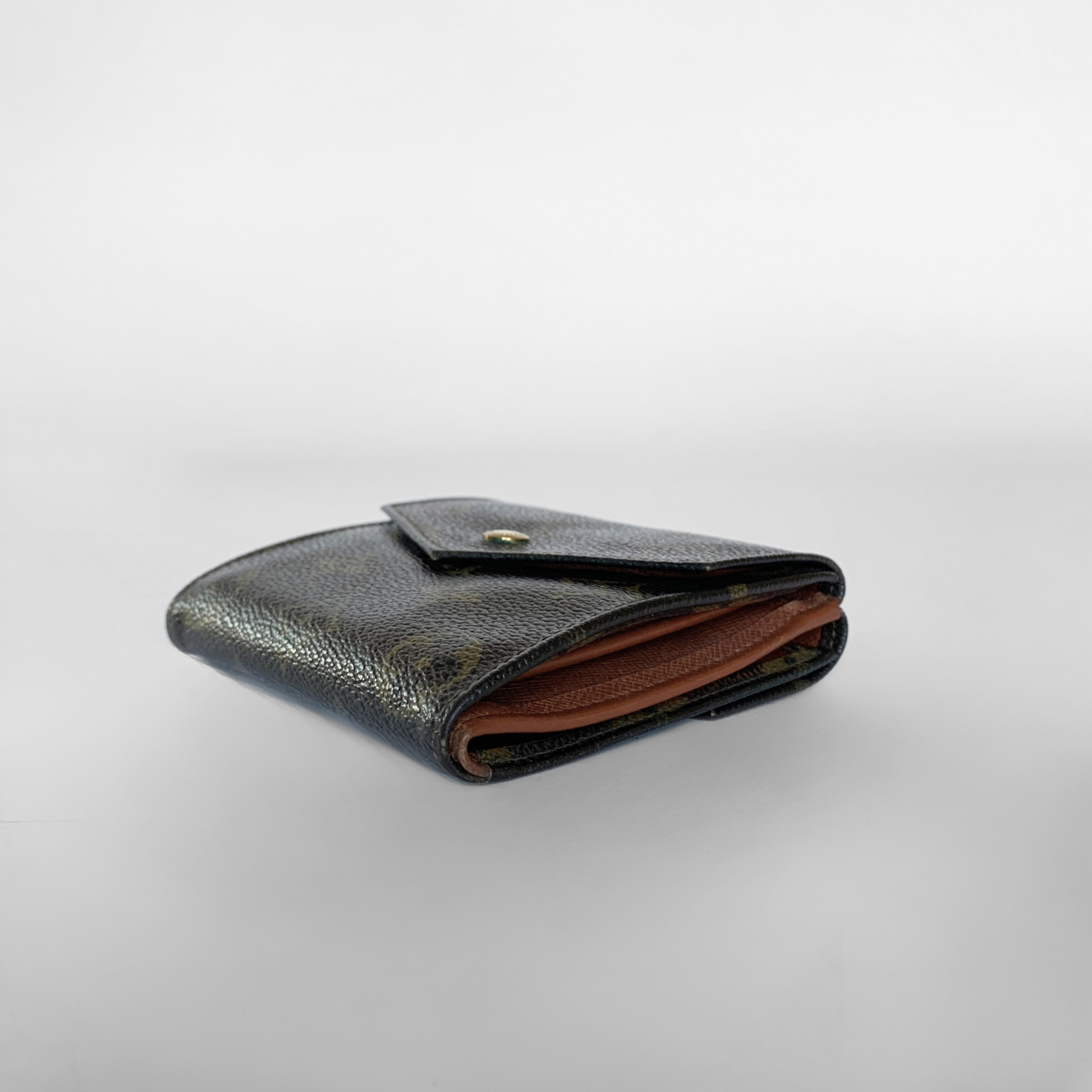Louis Vuitton wallet with monogram pattern on a light gray background