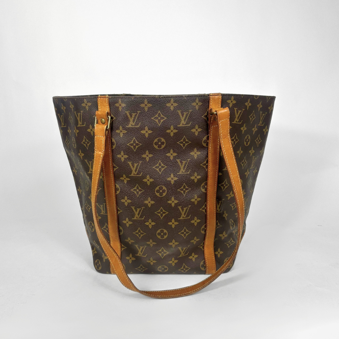 Designer handbag with monogram pattern on a white background