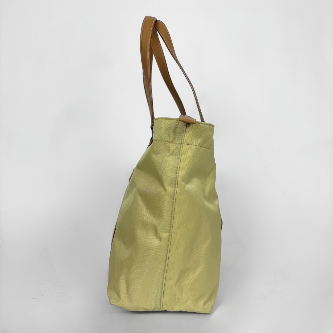 Prada yellow nylon tote bag with tan leather handles and triangle logo.