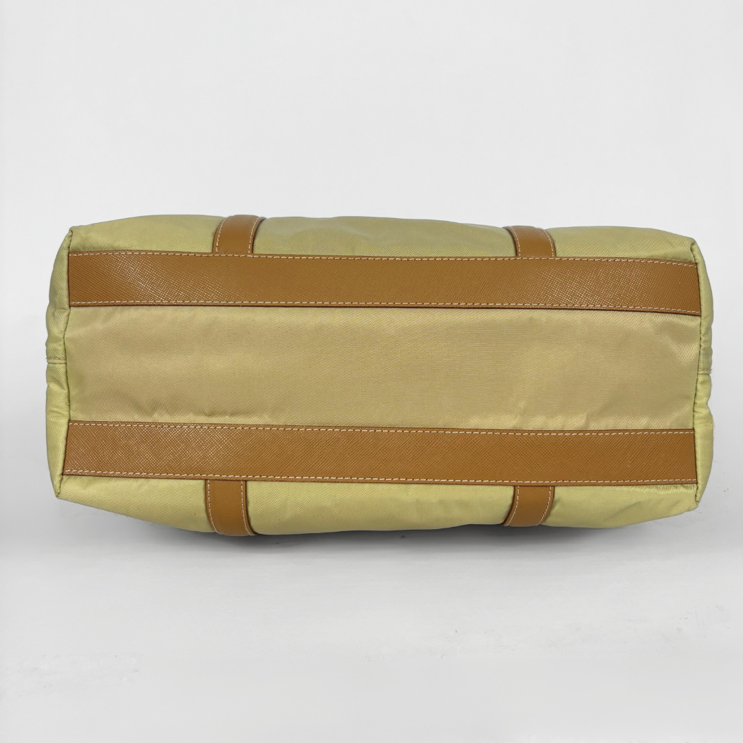 Prada yellow nylon tote bag with tan leather handles and triangle logo.