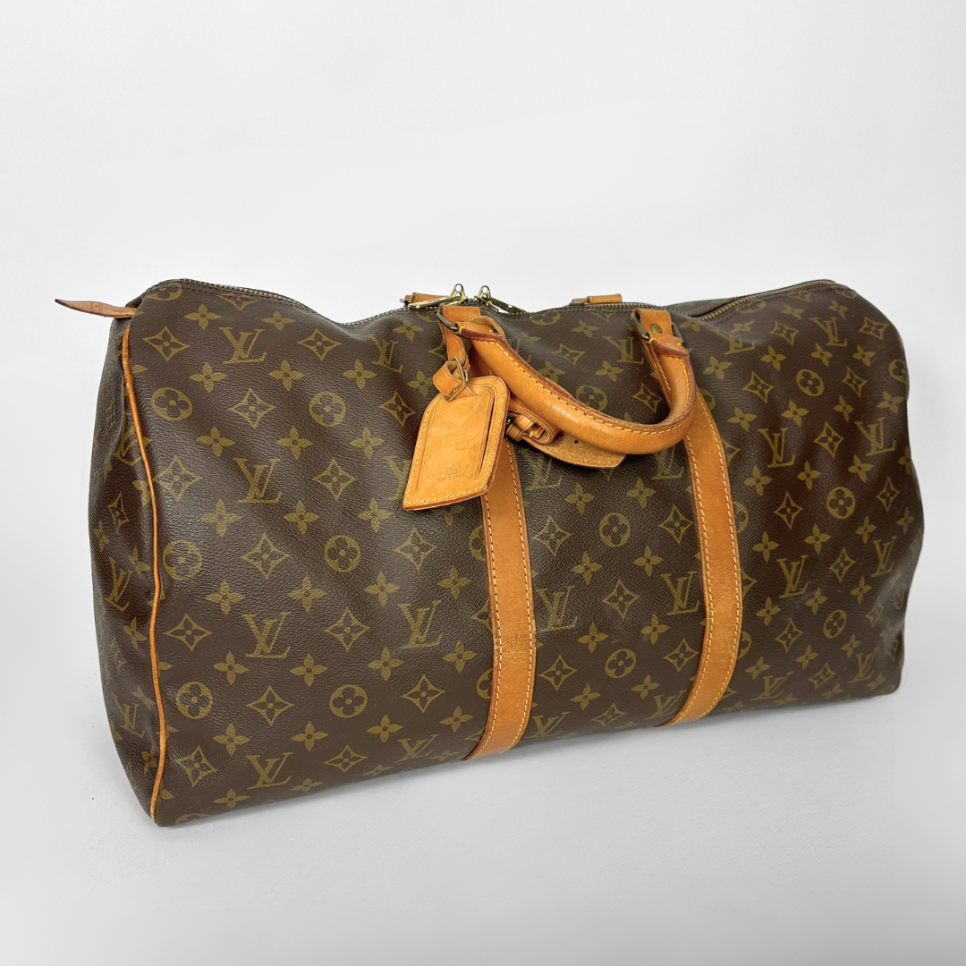 Brown Louis Vuitton bag with monogram pattern on a light gray background