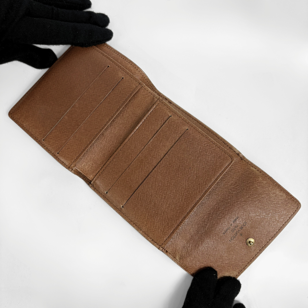 Louis Vuitton Druk Wallet on a white background