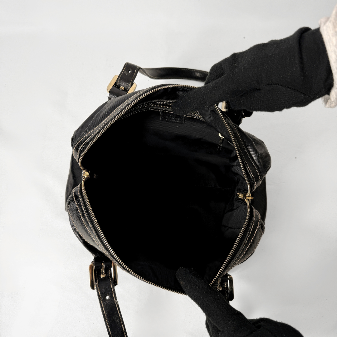 Gucci Dialux Britt Boston bag in signature Dialux canvas displayed on a light grey background.