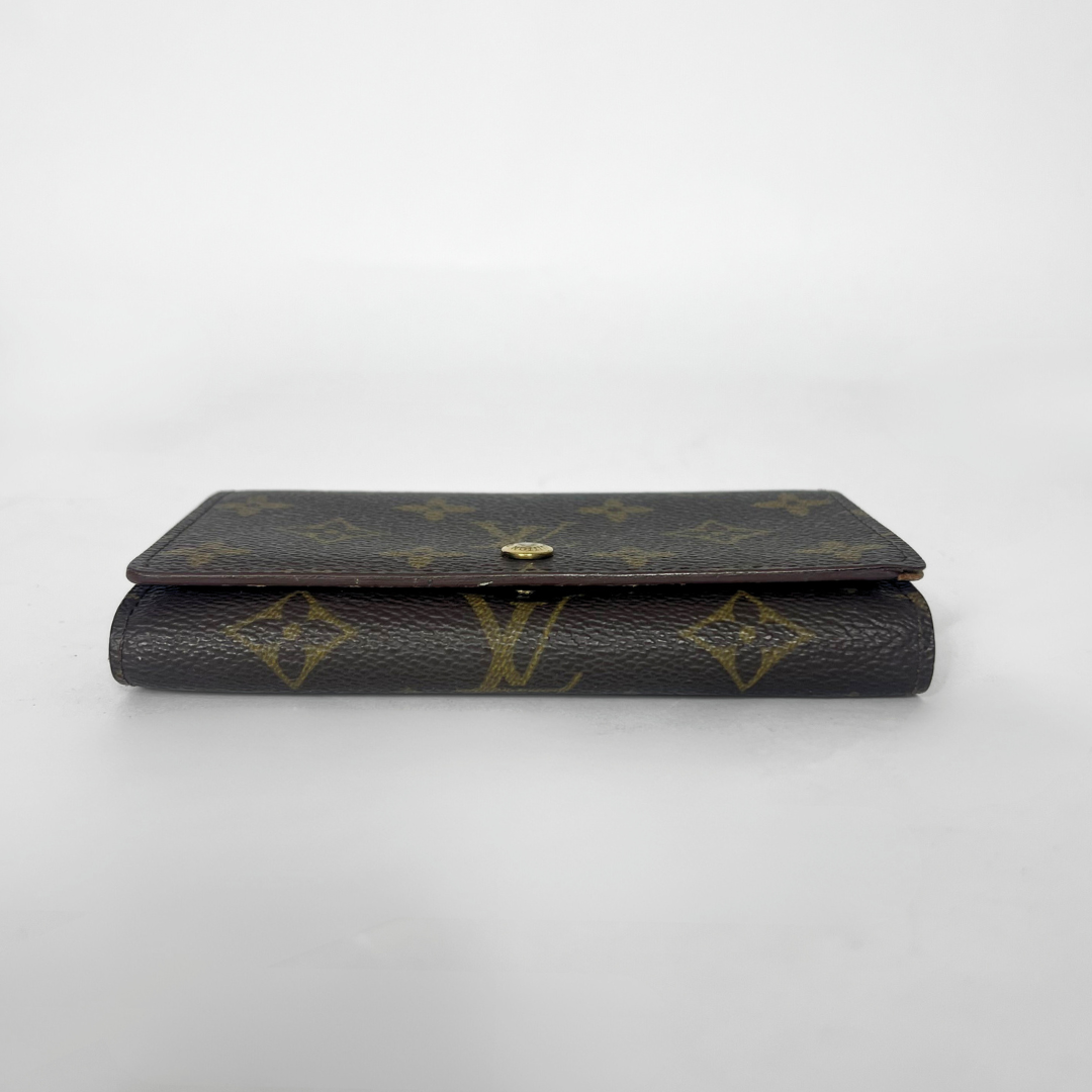 Folded wallet with brown leather interior on a white background