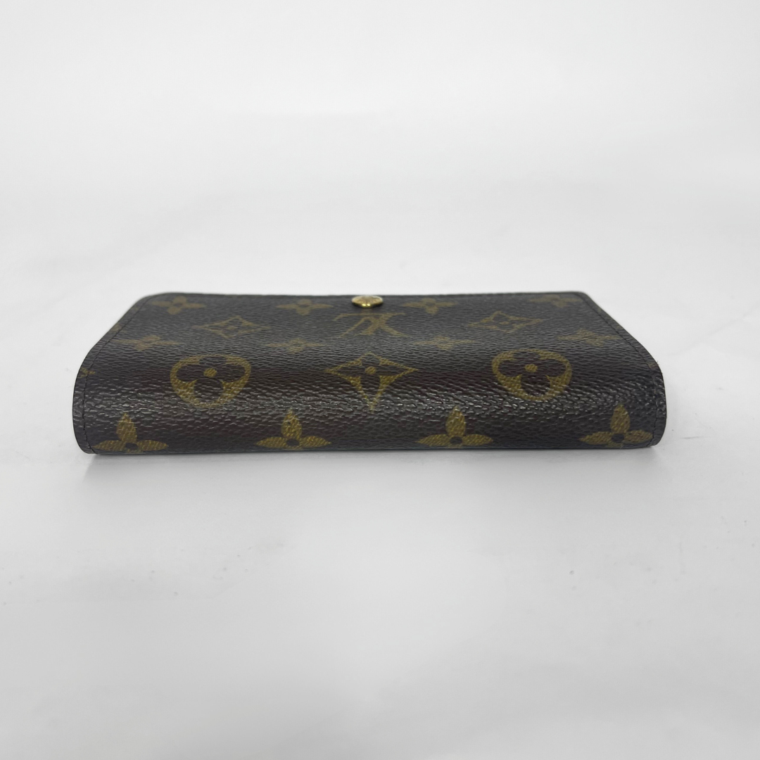 Folded wallet with brown leather interior on a white background