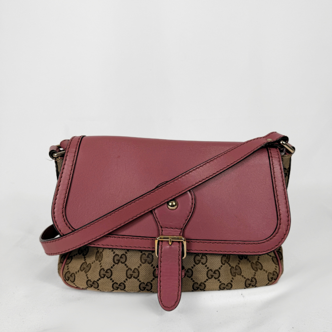 A vintage Gucci shoulder bag featuring a dusty rose leather flap and strap, combined with the classic brown and beige GG monogram canvas body, shown on a white background.