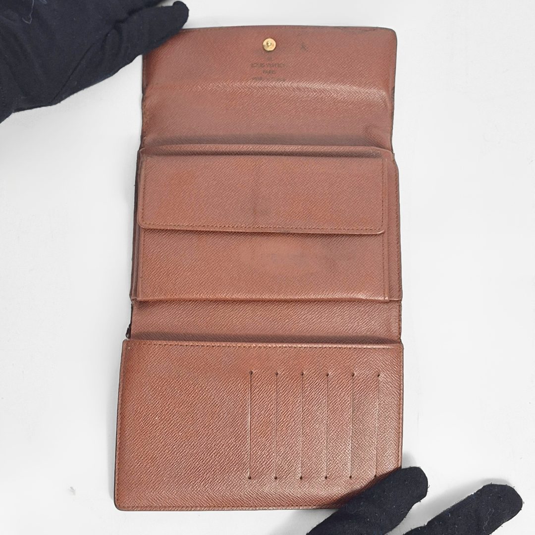 Brown wallet with visible brand logo on a white background