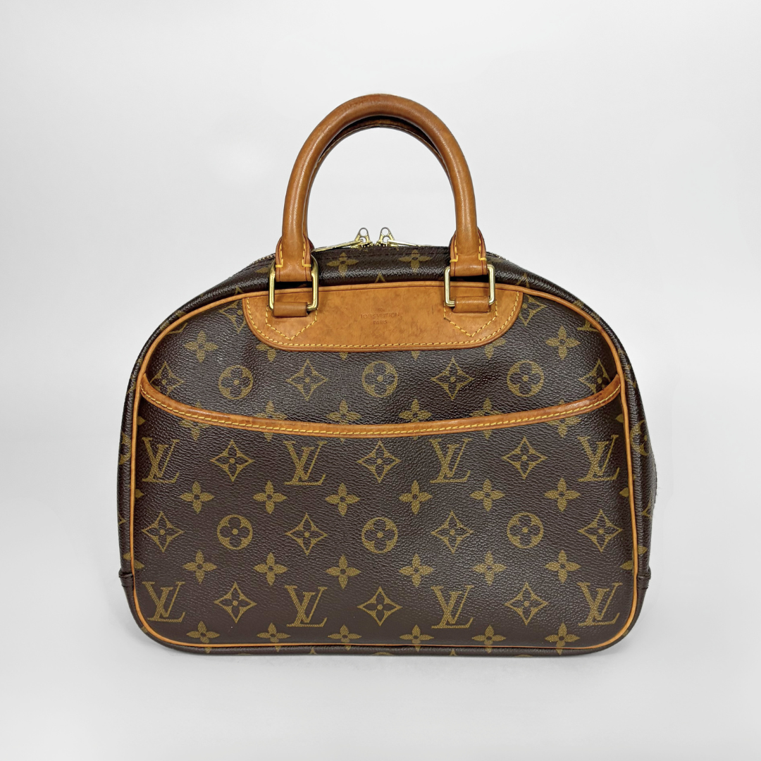 Louis Vuitton monogram canvas handbag with tan leather handles and trim, photographed against a light gray studio background.
