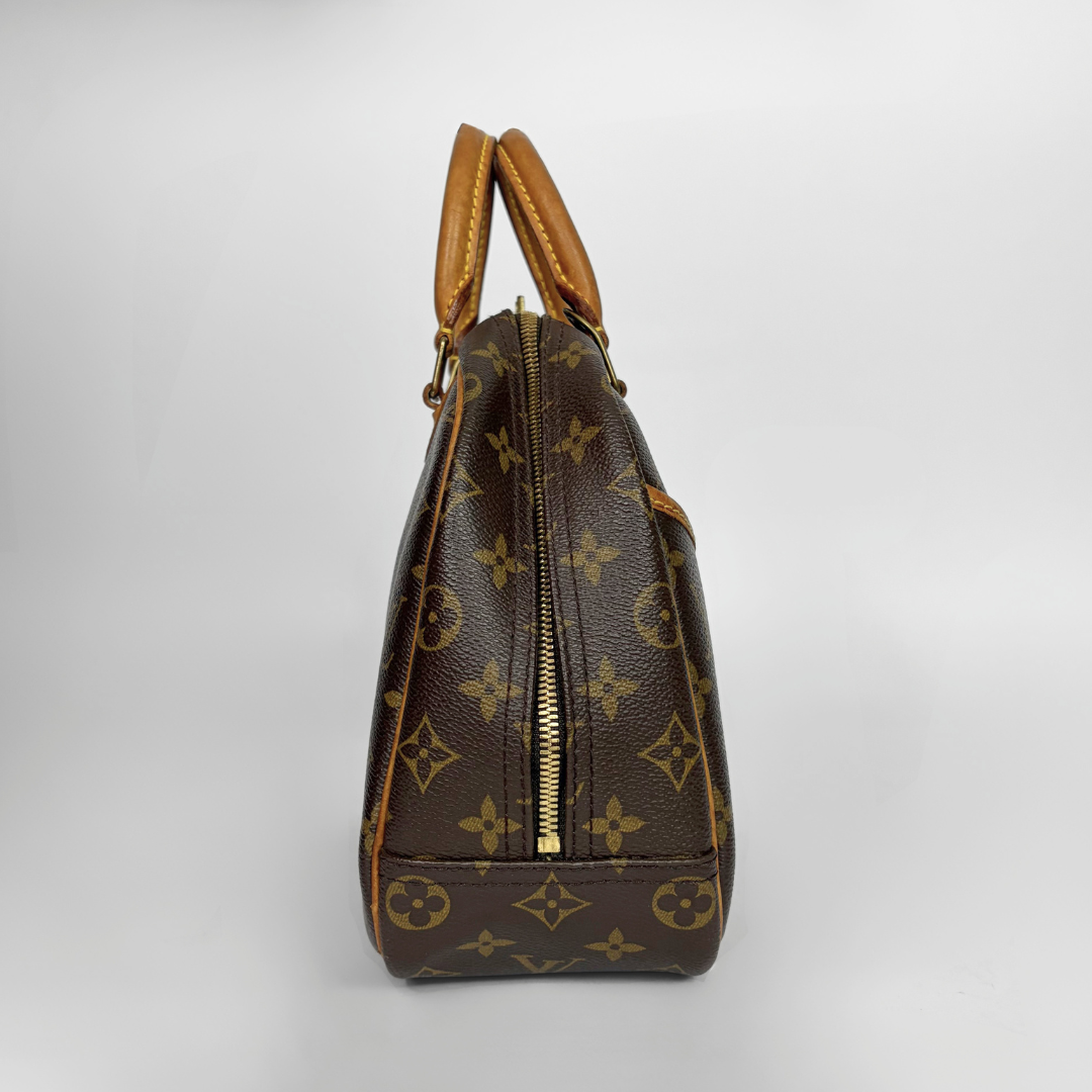 A Louis Vuitton monogram canvas handbag shown from the side against a light gray background.