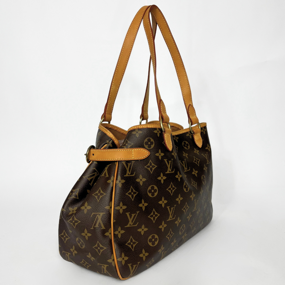 Brown handbag with tan leather straps on a white background