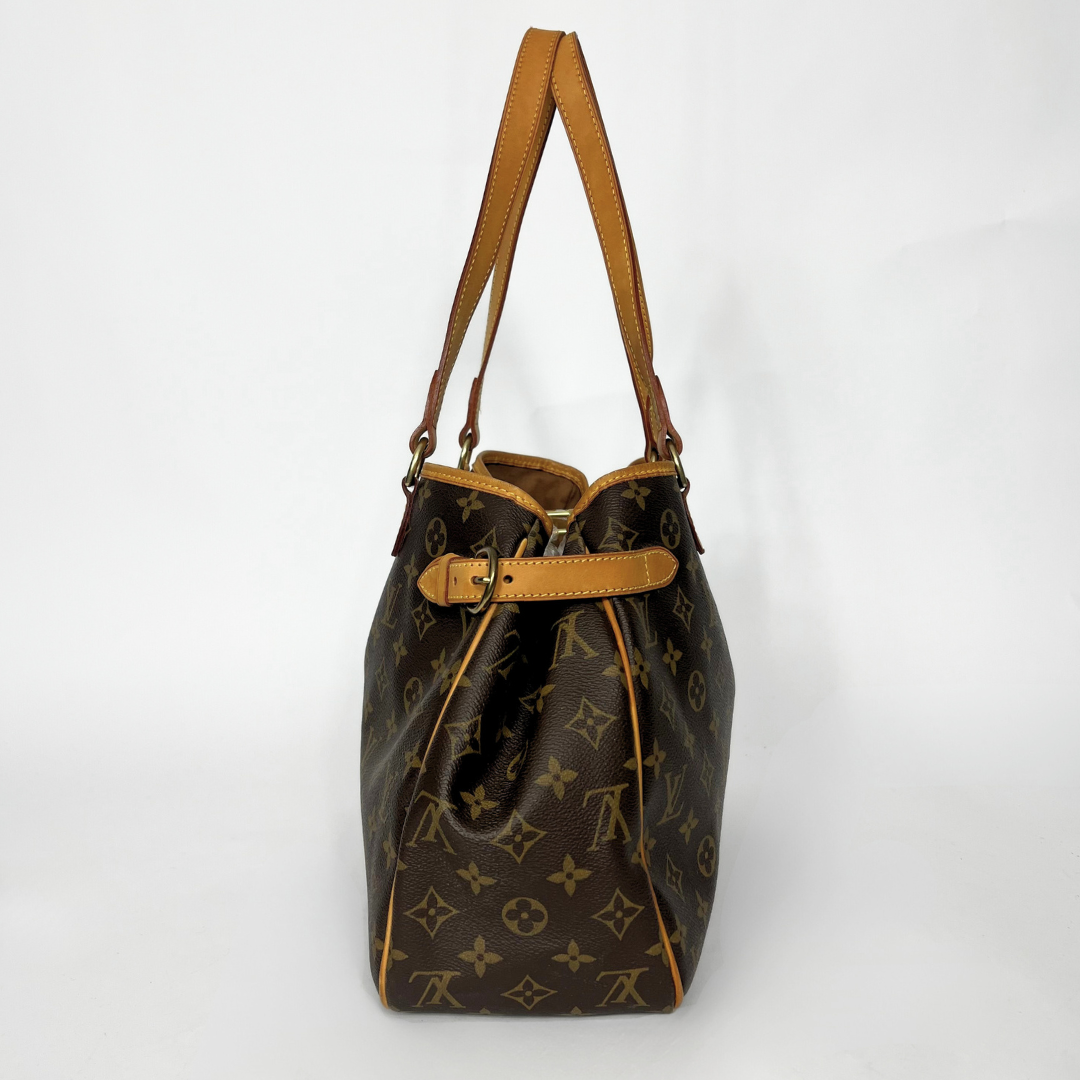 Designer handbag with monogram pattern on a white background