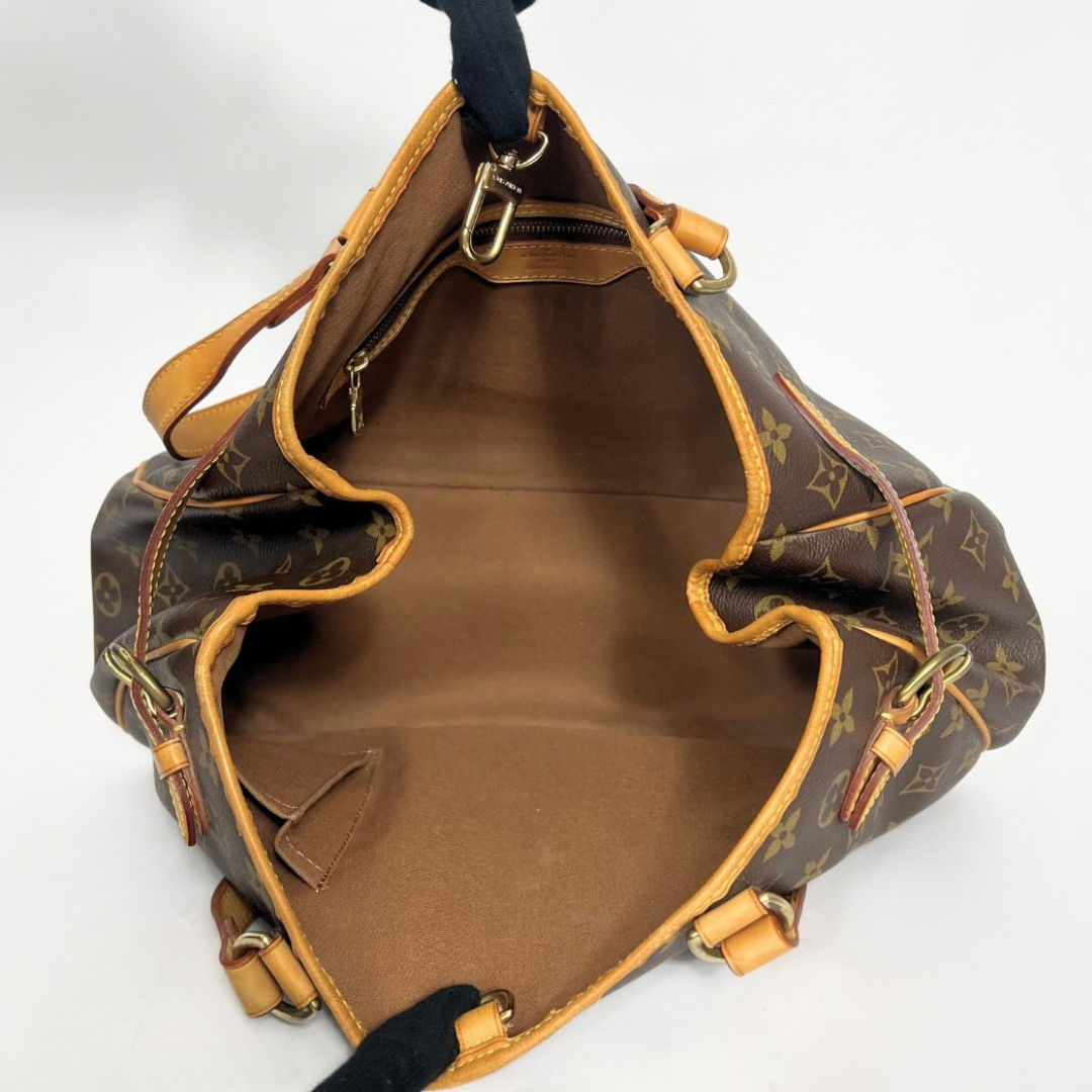 Brown leather handbag with gold accents on a white background