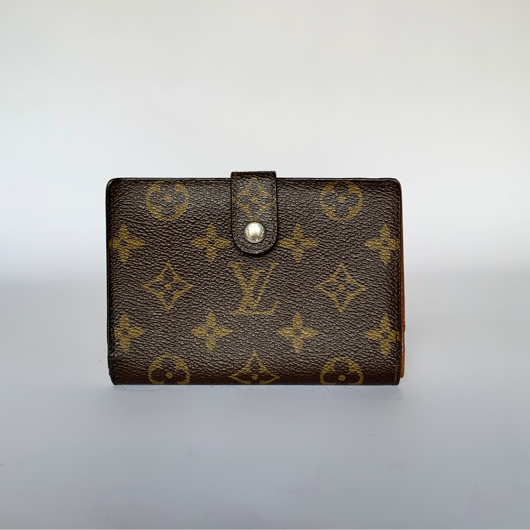 A Louis Vuitton monogram canvas bifold wallet with a snap button closure, photographed against a neutral light gray background.