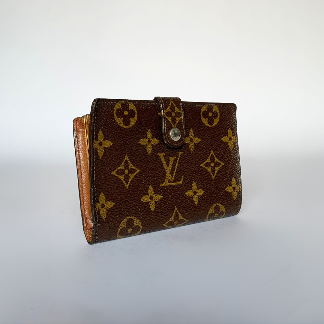 A Louis Vuitton monogram canvas bi-fold wallet in dark brown with gold-tone monogram motifs and a snap-button closure, photographed on a plain light background.