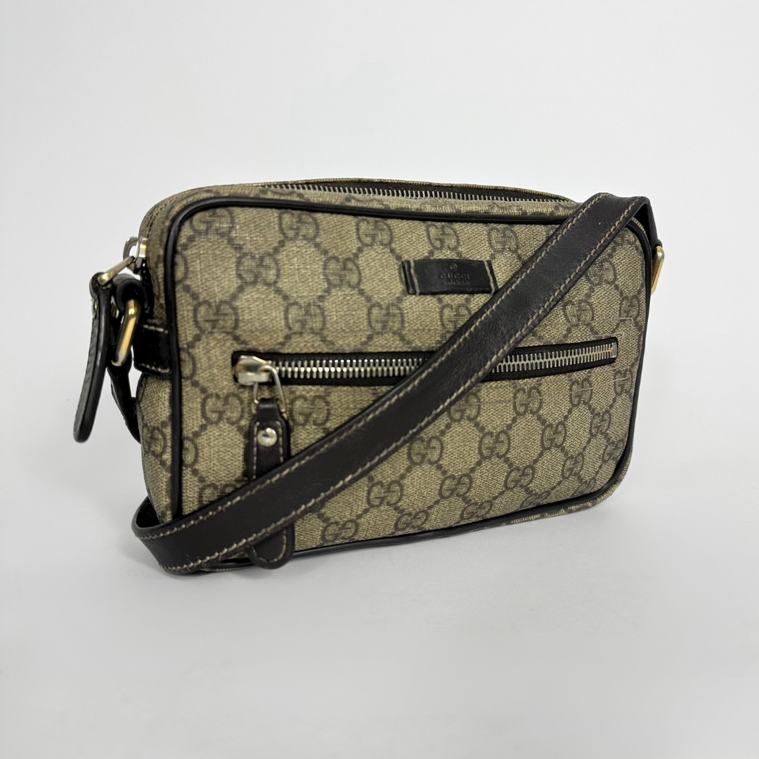 Gucci handbag with monogram pattern on a white background