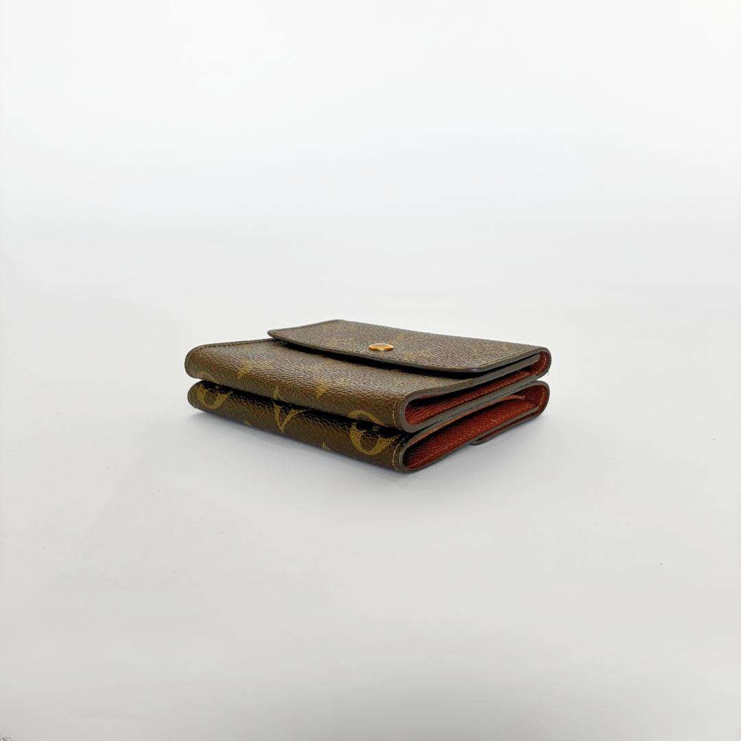 Louis Vuitton wallet with monogram pattern on a white background
