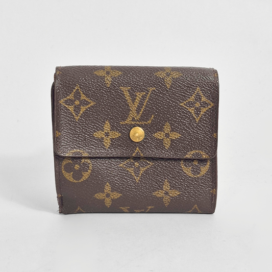 Brown wallet with gold monogram pattern on a light gray background