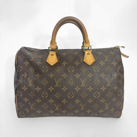 Designer handbag with monogram pattern on a white background