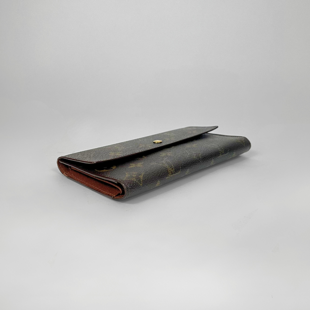 Louis Vuitton wallet on a light gray background