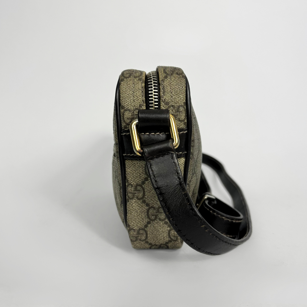 Gucci handbag with monogram pattern on a white background