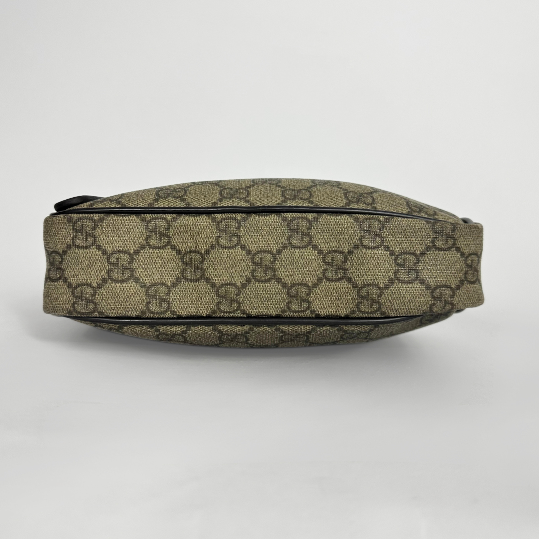 Gucci handbag with monogram pattern on a white background