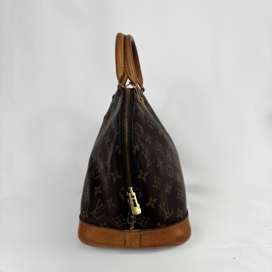Louis Vuitton monogram canvas handbag with tan leather trim and a gold-tone zipper, shown against a plain light gray background.