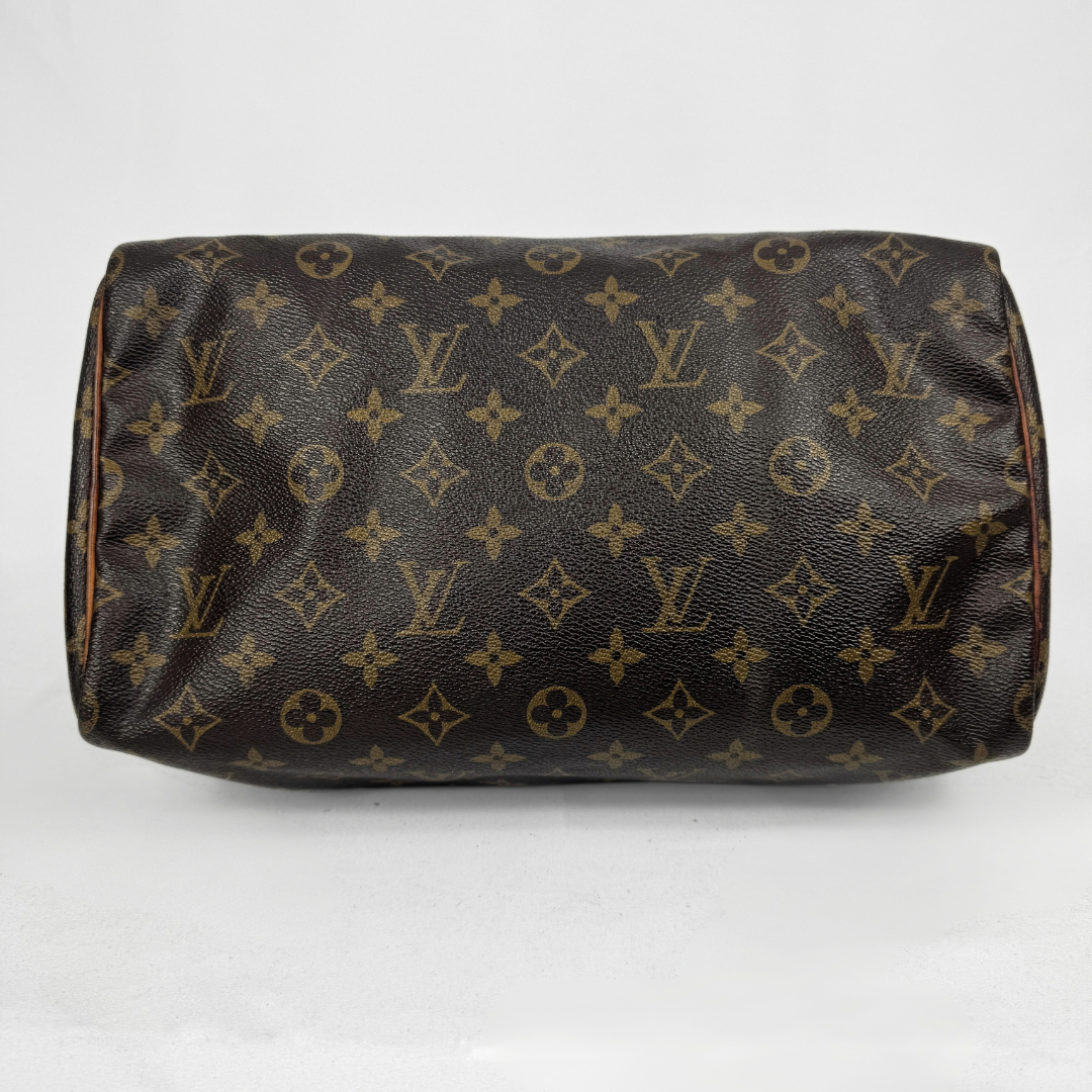 Louis Vuitton monogram canvas shoulder bag in dark brown with tan monogram print, shown against a plain light gray background.