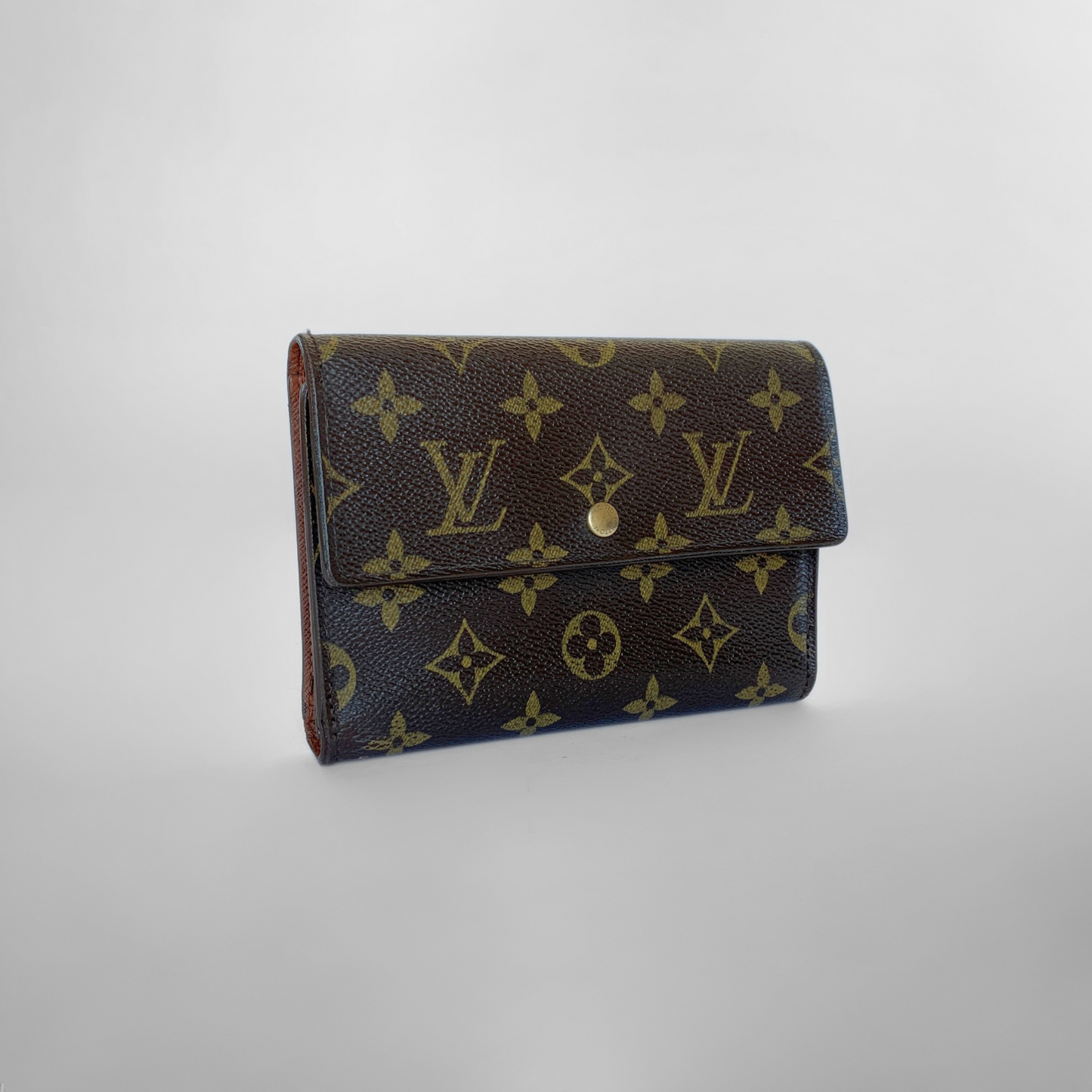 Louis Vuitton wallet with monogram pattern on a light gray background