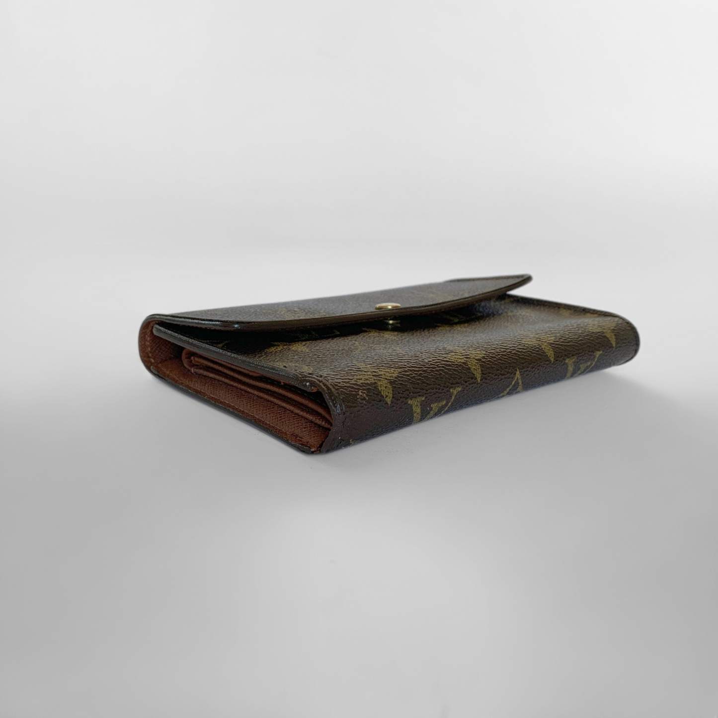 Brown leather wallet with gold accents on a light gray background