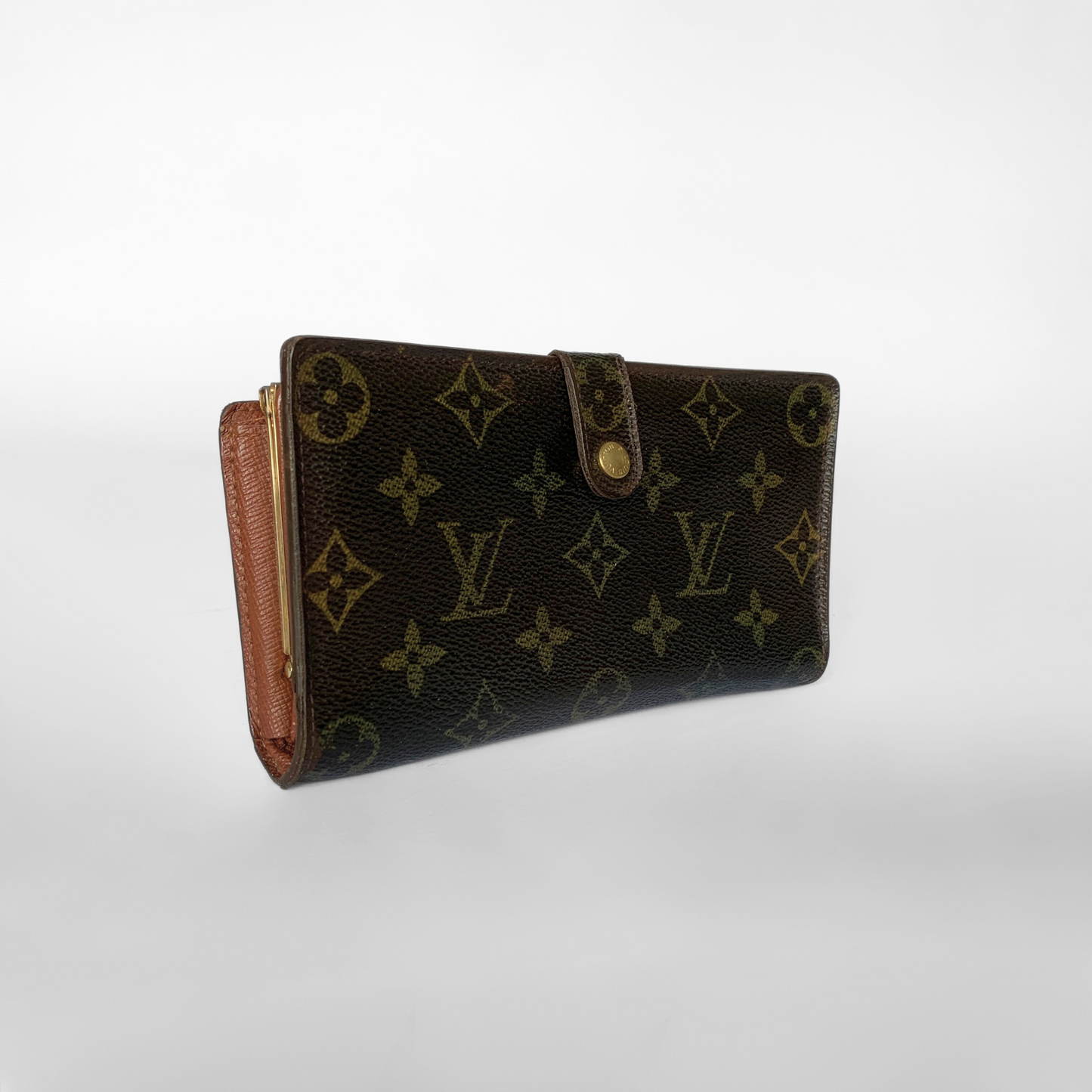 A Louis Vuitton monogram canvas wallet in dark brown with tan leather trim and a gold-tone snap closure, photographed on a light gray gradient background.