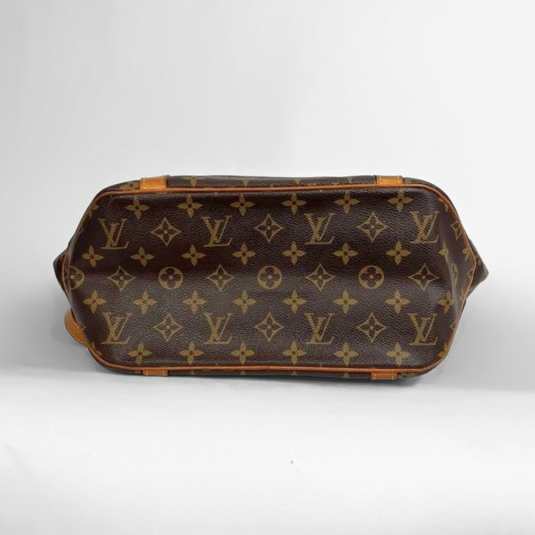 Louis Vuitton monogram canvas handbag shown from the back, featuring the classic brown and tan LV pattern on a light gray background.
