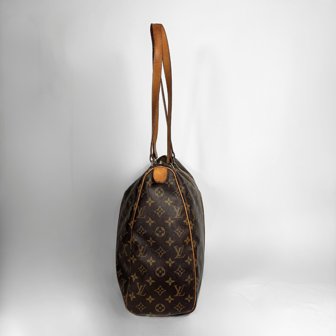 A Louis Vuitton monogram canvas shoulder bag in dark brown with tan leather trim and strap, shown against a light gray studio background.