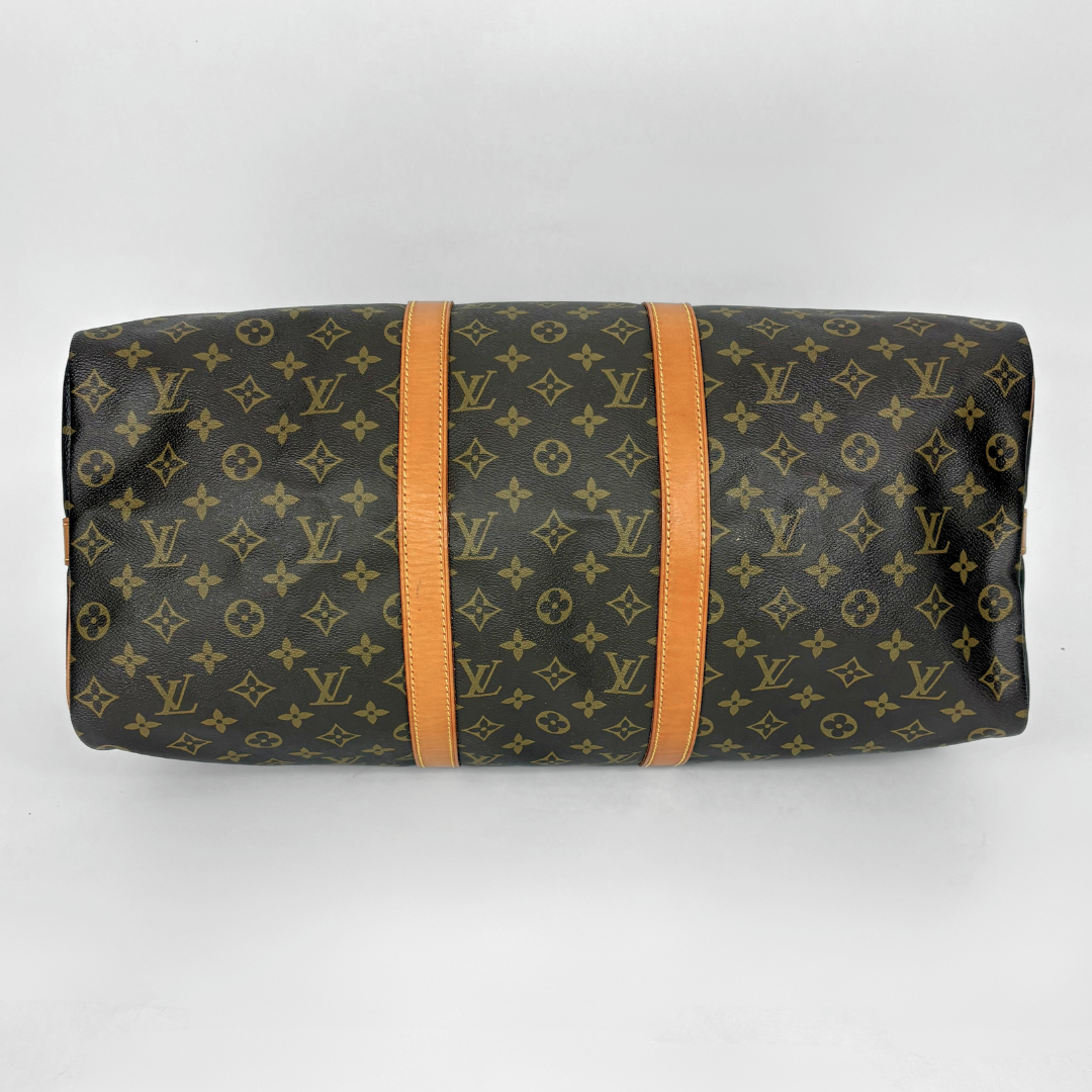 Louis Vuitton monogram bag with orange straps on a white background