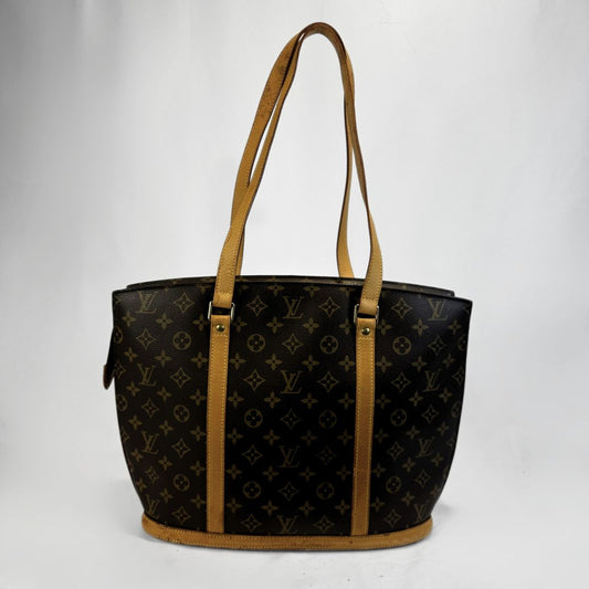 Louis Vuitton monogram canvas Babylon with tan leather shoulder straps and trim, shown against a plain white background.