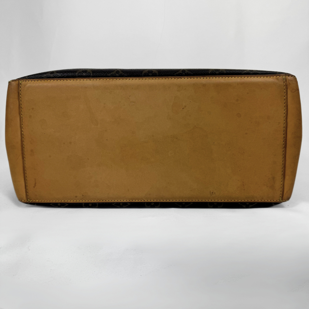 A Louis Vuitton shoulder bag in tan leather with the brand's dark brown monogram pattern visible along the top edge and sides, shown against a plain white background.