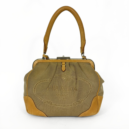 Prada handbag with brown leather accents on a white background