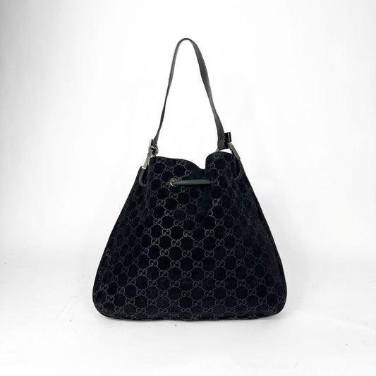 Black patterned handbag on a white background