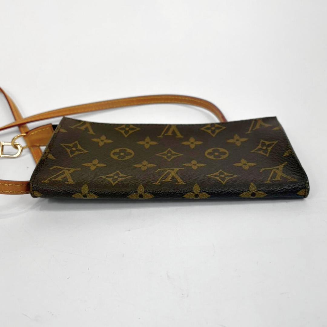 Brown handbag with gold monogram pattern on a white background