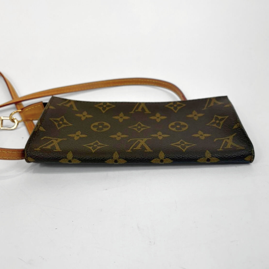 Brown handbag with gold monogram pattern on a white background