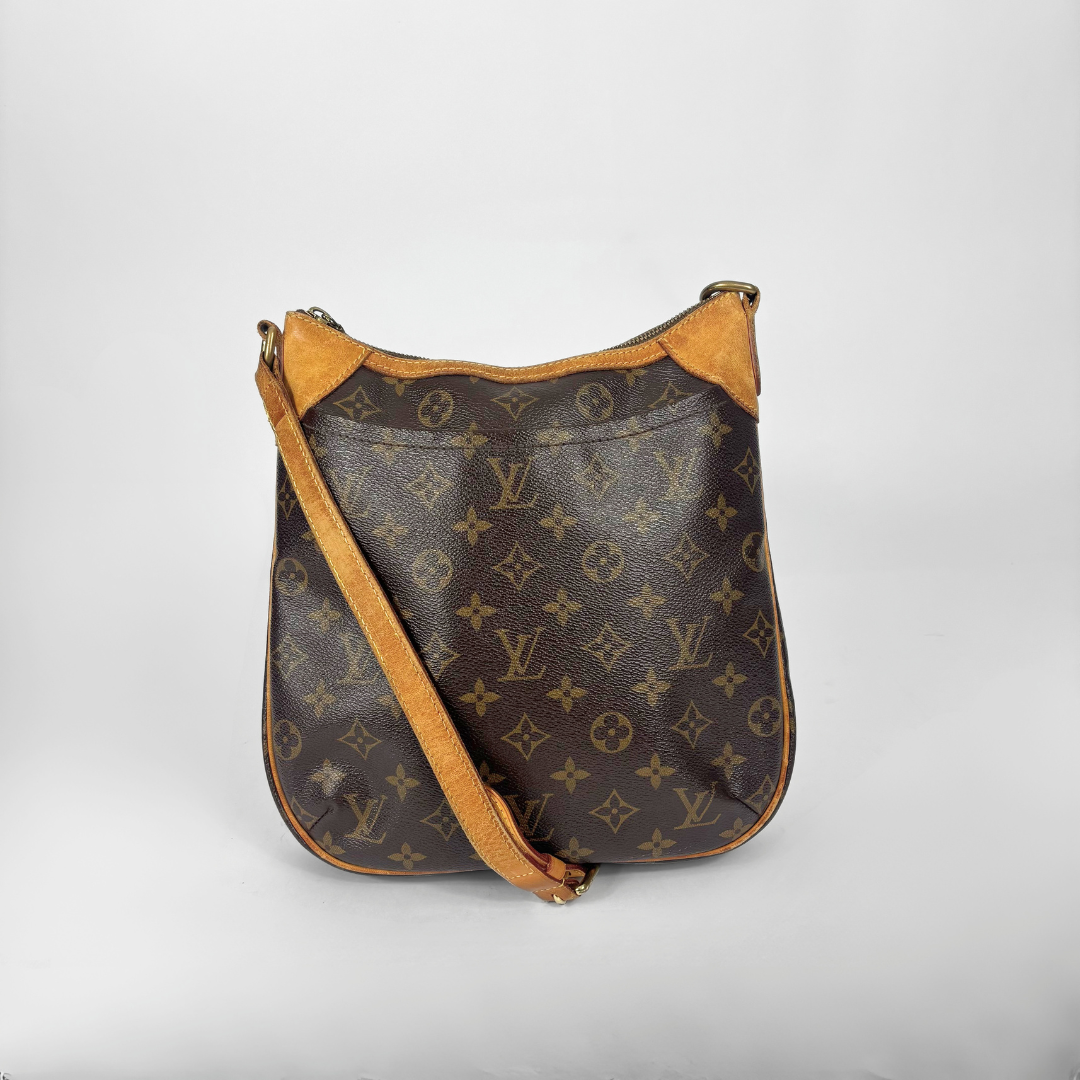 Designer handbag with monogram pattern on a light gray background