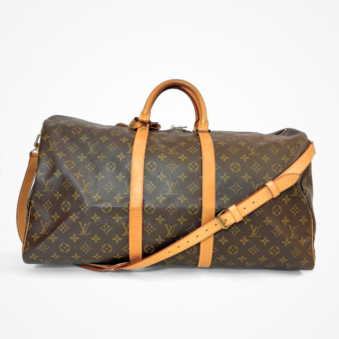 Brown LV duffel bag with monogram canvas and tan leather straps on a white background