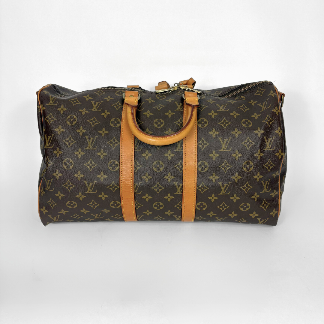 Designer handbag with monogram pattern on a white background
