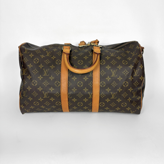Designer handbag with monogram pattern on a white background