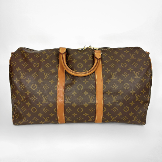 Brown travel bag with tan handles and trim on a white background