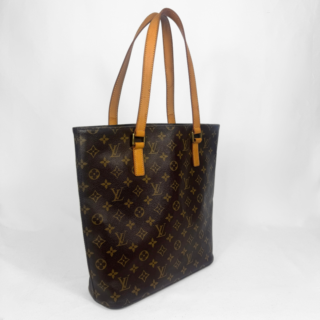 A Louis Vuitton monogram canvas bag with dark brown coated canvas, tan monogram print, and tan leather shoulder straps, shown on a white studio background.